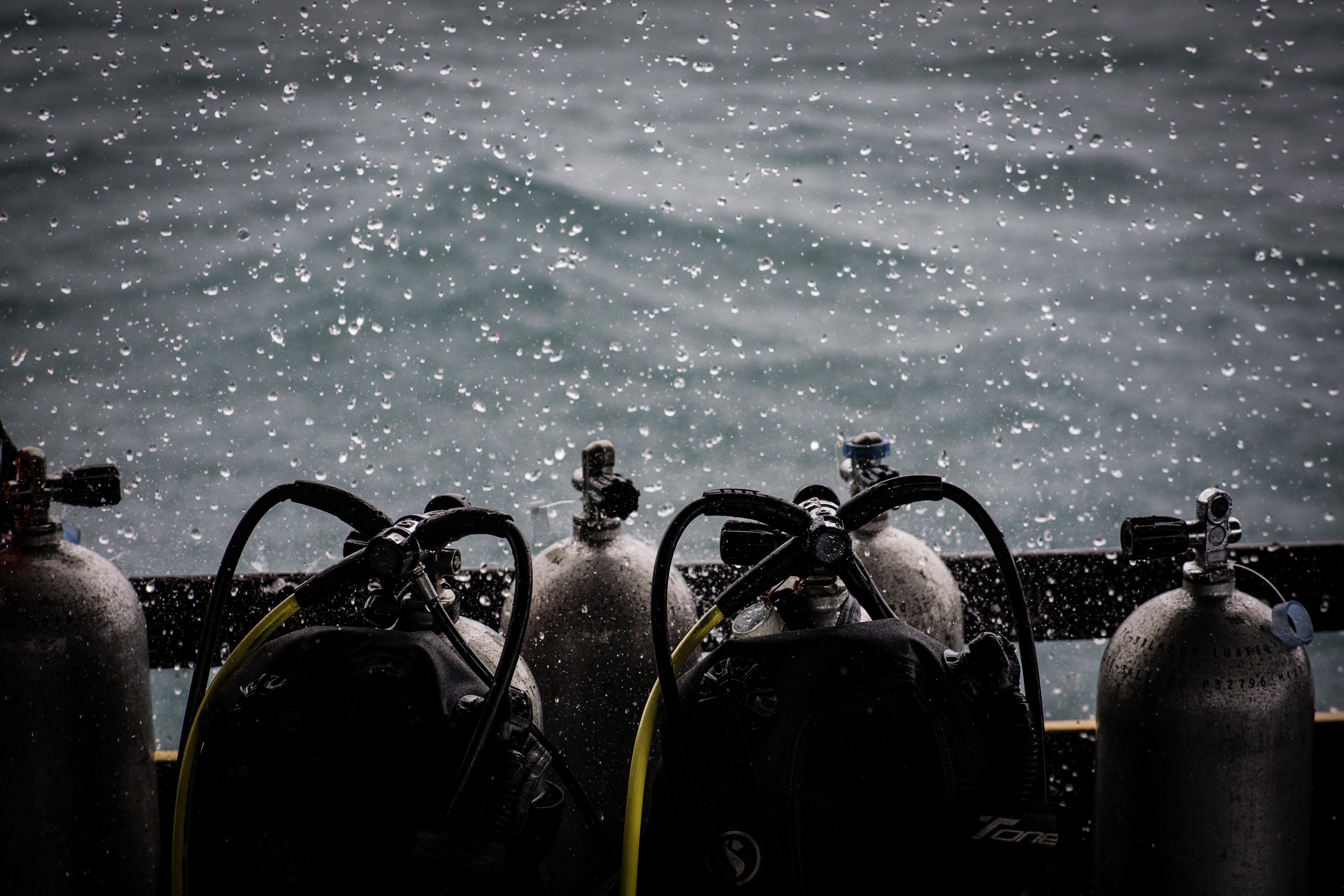 Rain falling on a row of SCUBA tanks